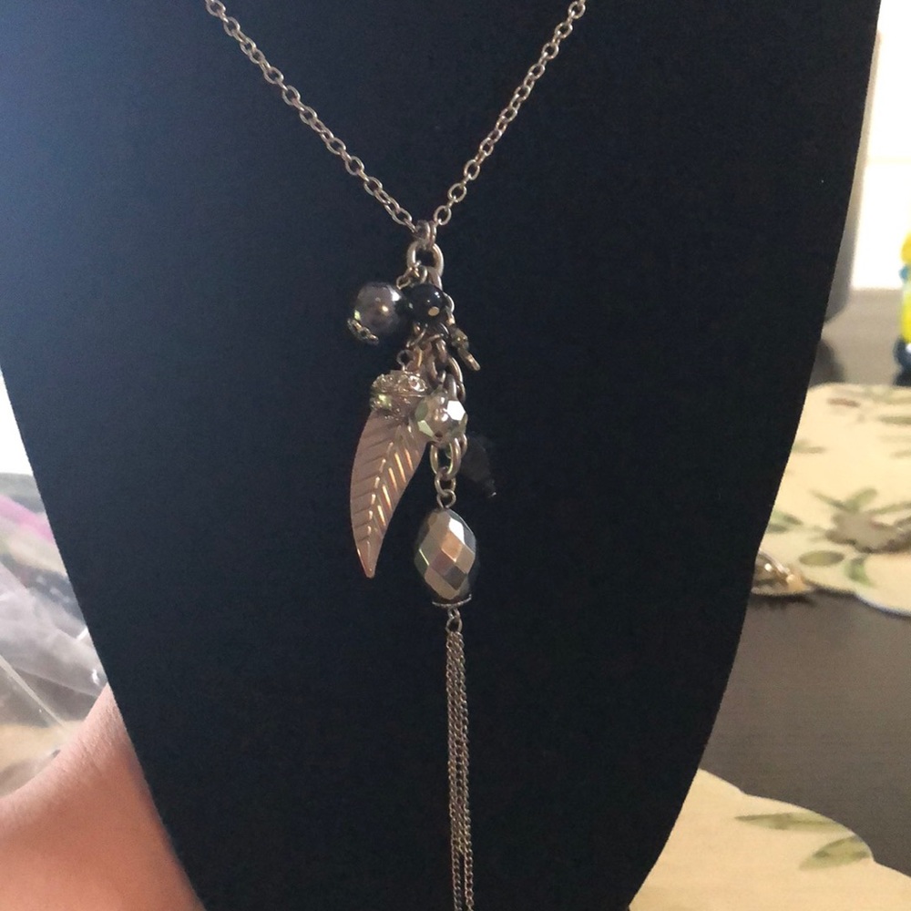 Silver tone multi pendant fashion necklace.